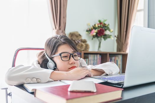 Teenage girl short hair relaxed after working on laptop while sit near window at home office