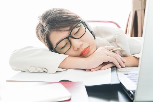 Teenage girl short hair sleep on desk after working on laptop while sit near window at home office