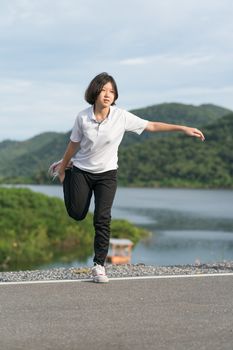 Fitness and lifestyle concept - Young asian woman short hair doing exercising outdoor