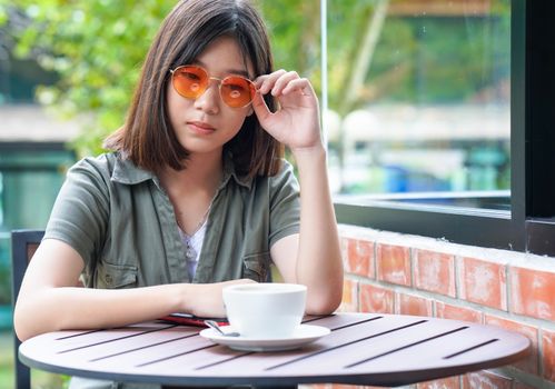 Pretty woman sitting in a cafe terrace with coffee cup