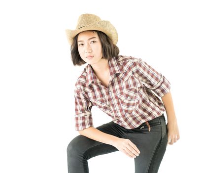 Young pretty woman in a cowboy hat and plaid shirt with isolated on white background