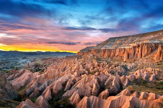 Beautiful mountains and Red valley  at sunset in Goreme, Cappadocia in Turkey.
