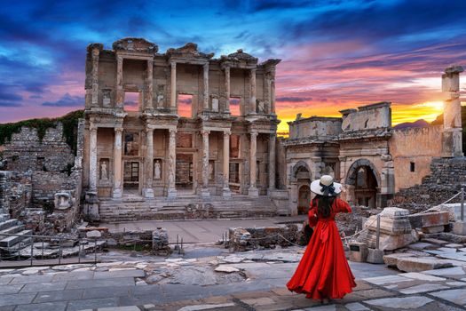 Woman standing in Celsus Library at Ephesus ancient city in Izmir, Turkey.