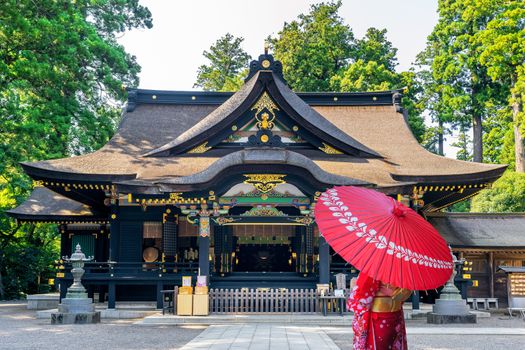 Woman wearing japanese traditional kimono with umbrella at katori shrine in Chiba, Japan.