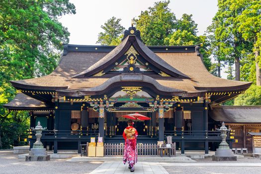 Woman wearing japanese traditional kimono with umbrella at katori shrine in Chiba, Japan.