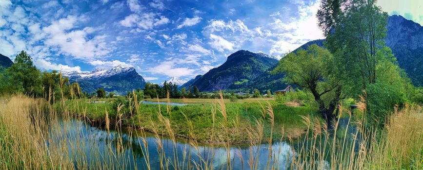 Panorama in canton Uri, Switzerland with swiss Alps and cloudy Sky