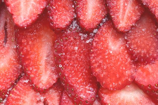 Red healthy tasty strawberry’s with sugar texture. Fresh vitamin berry backdrop. Sliced strawberry in sugar filling background.