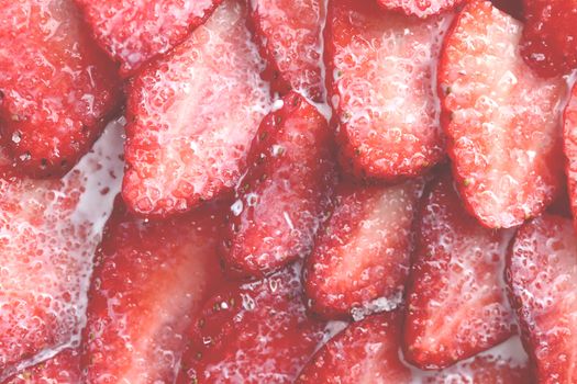 Red healthy tasty strawberry’s with sugar plum texture. Fresh vitamin berry backdrop. Sliced strawberry in sugar cream filling background.