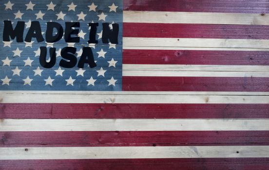 Large text letters spelling Made in USA on vintage wooden United States flag