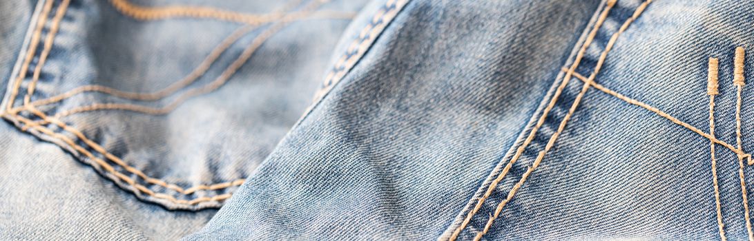 Close-up of blue denim texture. Denim jeans background, space to copy your design or text.