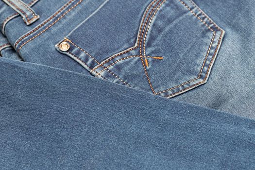 Close-up of blue denim texture. Denim jeans background, space to copy your design or text.