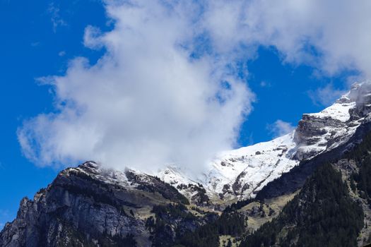 swiss mountain peak with blue sky and clouds. with copy space
