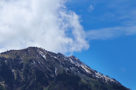 swiss mountain peak with blue sky and clouds. with copy space