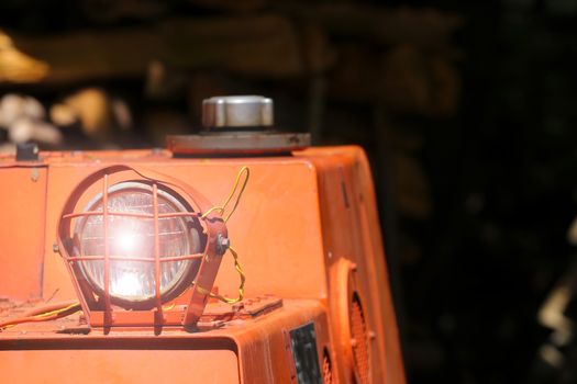 Bulldozer headlight, huge orange powerful construction machine with light equipment