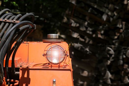 Bulldozer headlight, huge orange powerful construction machine with light equipment