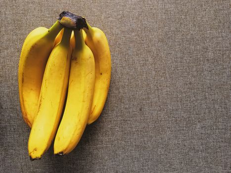 Organic bananas on rustic linen background, fruits farming and agriculture