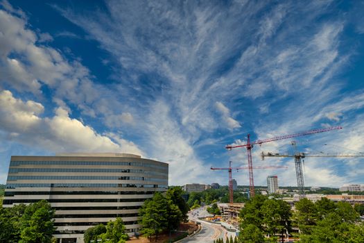 Three construction cranes at a new high rise site