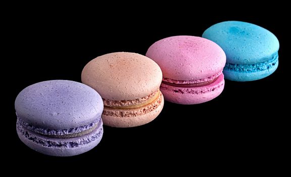 Macaroons in row diagonally on black background