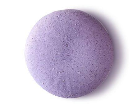 One purple macaroon top view on white background