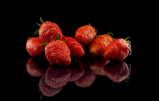 red strawberries isolated on black background