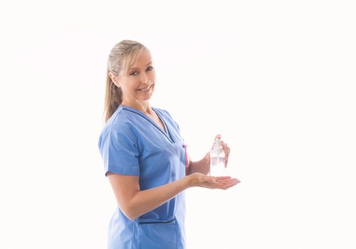 Nurse or healthcare professional demonstrating use of hand sanitizer.  COVID-19 coronavirus pandemic has had an impact on the sale and use of hand sanitizer for hand hygiene to stop the spread