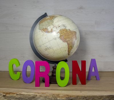 globe with the text Corona ion wooden shelf