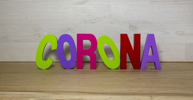 text corona in colors on wood banner