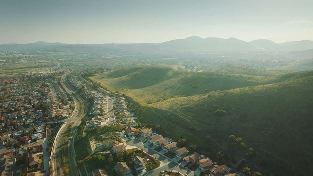 Aerial Flying over California Suburb. Aerial Landscape View For City and Mountain.