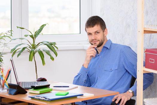 Confident specialist at the workplace in the office