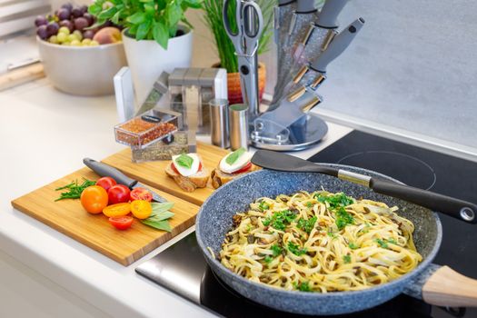 Traditional italian cuisine with appetizing and delicious fettuccine pasta dish on counter top from angled view.