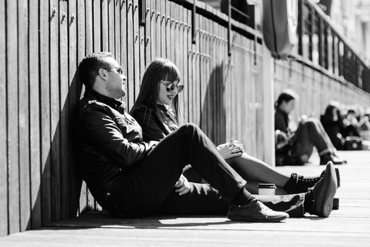 happy guy and girl walking along the tourist streets of old Europe in the city of Gdansk