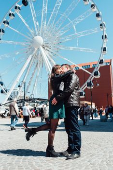 happy guy and girl walking along the tourist streets of old Europe in the city of Gdansk