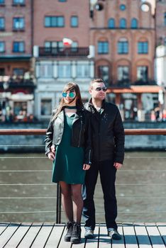 happy guy and girl walking along the tourist streets of old Europe in the city of Gdansk