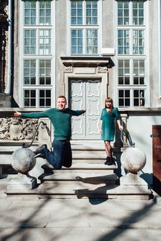 happy guy and girl walking along the tourist streets of old Europe in the city of Gdansk