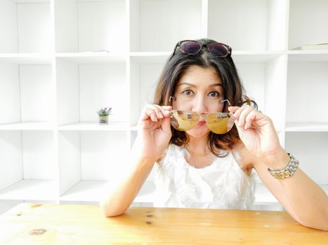 Beautiful woman and the eyeglasses against white background.
