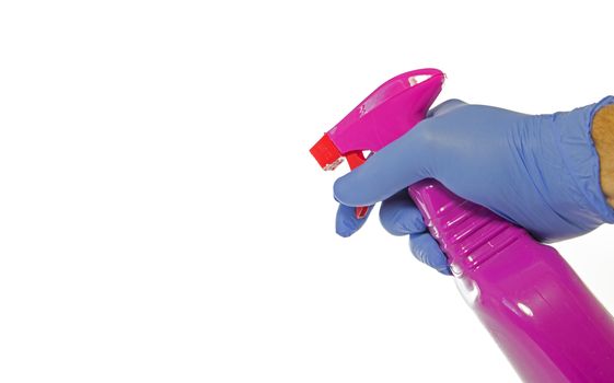 Cleaning supplies on white background and hand in glove holding a desinfection spray