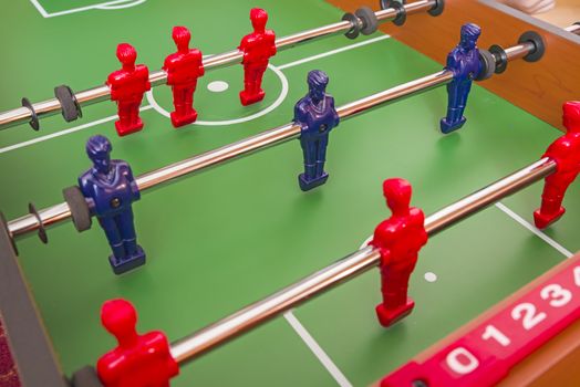Installing figurine lines at football table game, close image