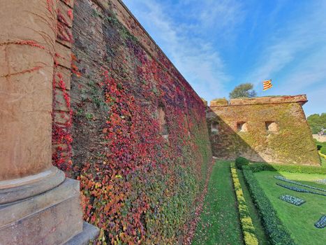 Green yard and ancient fortification, Montjuic Castle, well known landmark in Barcelona.