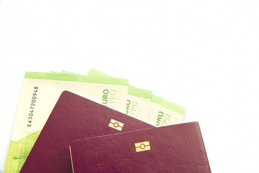 Euro banknotes in biometric passport over white background