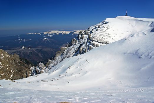 Winter mountain landscape in Romanian Carpathians, sunny day in alpine area.