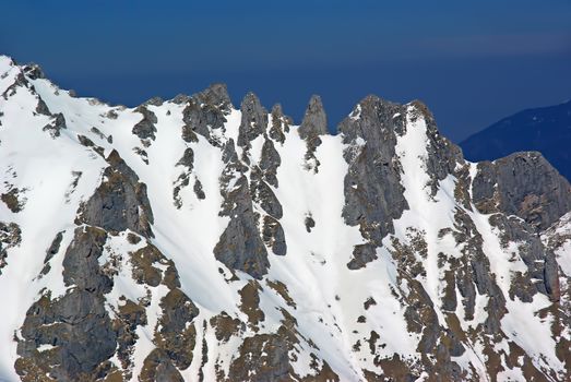 Rocky winter crest in Romanian Carpathians in sunlight