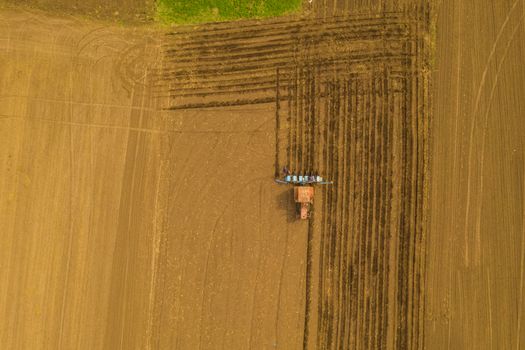 Seeding traktor on spring field, up view