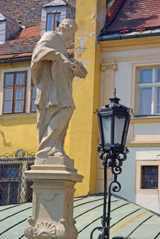 Historical center of Bratislava details, old statue and street lamp