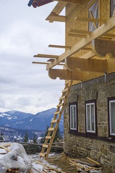 Mountain chalet construction site, exterior working