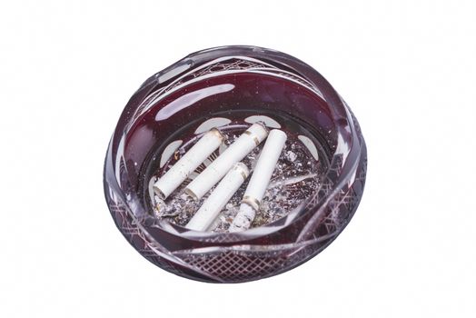 Cigarette butts in the ashtray over a white bacground