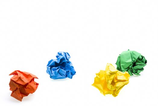 Colored crumpled paper ball over white, focus on second row