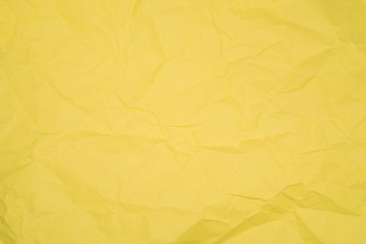 Texture of yellow crumpled paper, close image