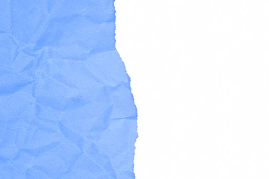 White ripped papper and blue crumpled background