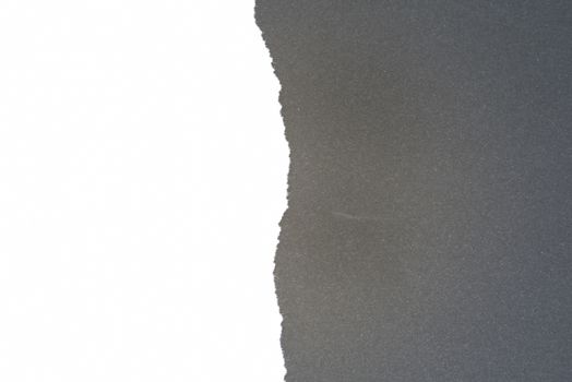 Half ripped white paper with black background