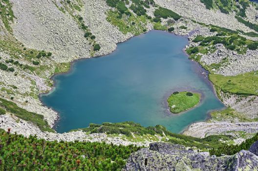 Green alpine lake in a summer landscape, Romanian Carpathians scene